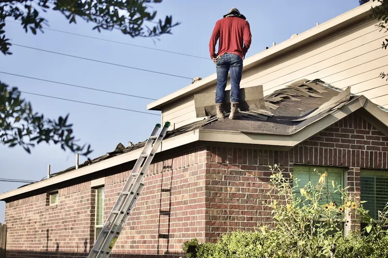 Professional roofer working on a residential roof in Danbury